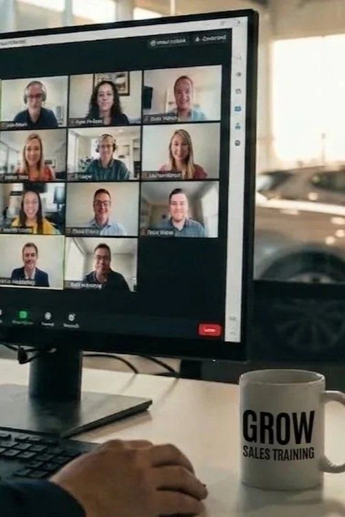 Zoom coaching call on a desktop monitor with a Grow Sales Training coffee mug